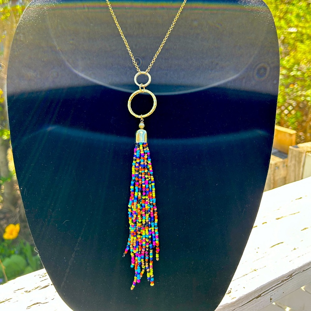 Gold tone chain and beaded tassel necklace.